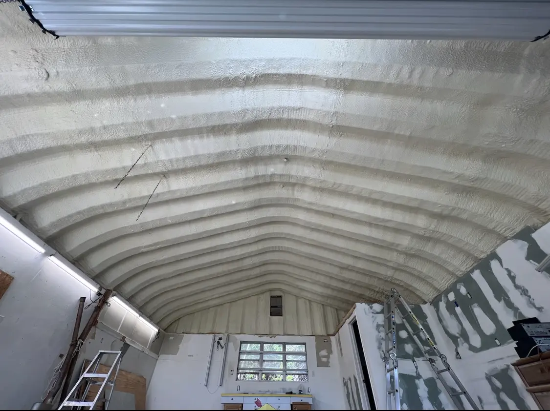 Spray polyurethane foam applied to the underside of a metal roof deck in Newport